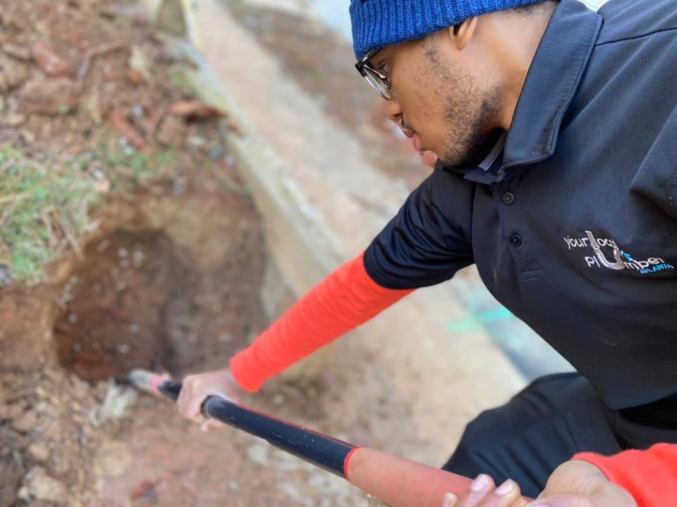 YLP ATL plumber performing water line excavation at a residential site